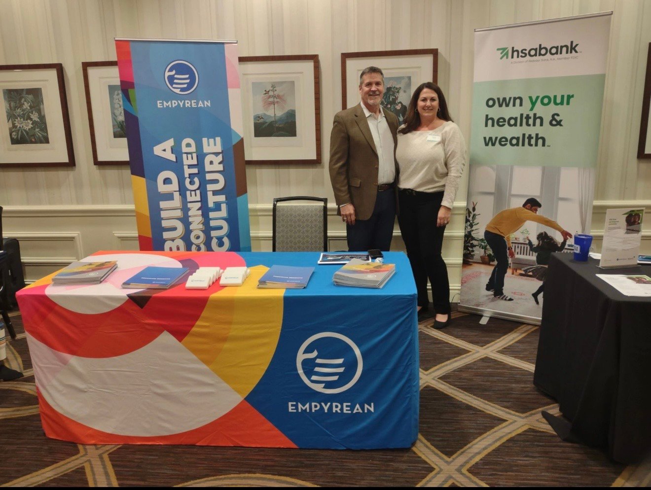 Two Empyrean employees at company table